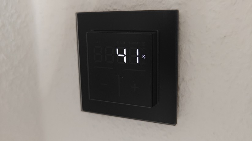 Das Homematic IP Glas-Wandthermostat mit CO₂-Sensor gibt es in Schwarz oder Weiß. Auf seinem Glas-Display kann es Temperatur, Luftfeuchte und CO₂-Konzentration abwechselnd anzeigen.