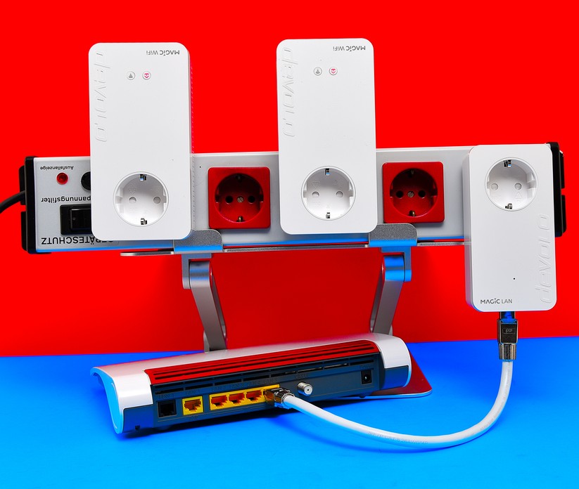 Durch bloßes Einstecken im gleichen Stromkreislauf synchronisierten sich die drei weißen Powerline-Adapter hier gerade vollautomatisch. Am Ende leuchteten auch die roten LEDs dauerhaft weiß (Bild: Harald Karcher).