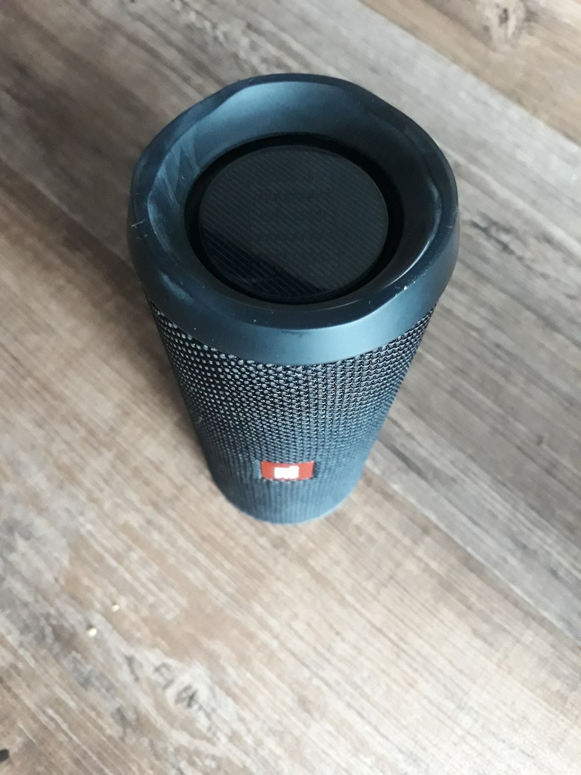 JBL hat den Flip 4 oben, unten sowie auf der Rückseite mit einer Silikonummantelung versehen, die den Lautsprecher vor Stürzen schützen soll – lediglich die Front mit dem JBL-Logo bleibt frei.