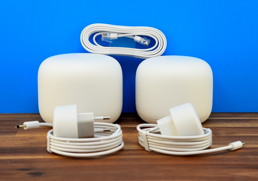 Lieferumfang des getesteten Google Nest Wifi Mesh Sets zum UVP von 259 Euro: Links der Nest Wifi Router. Rechts der Nest Wifi Zugangspunkt. Oben drauf ein flaches Ethernetkabel. Vorne zwei 15-Watt-Netzteile (Bild: Harald Karcher).